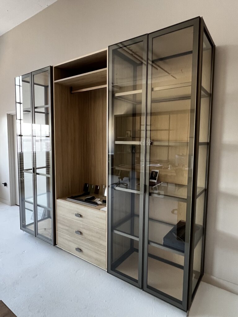 Aluminum-framed glass wardrobe with wood interior and drawers