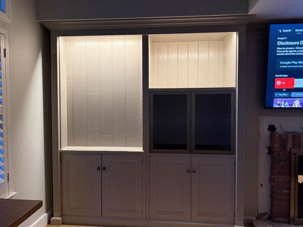 Built-in cabinet with aluminum-framed textured glass doors