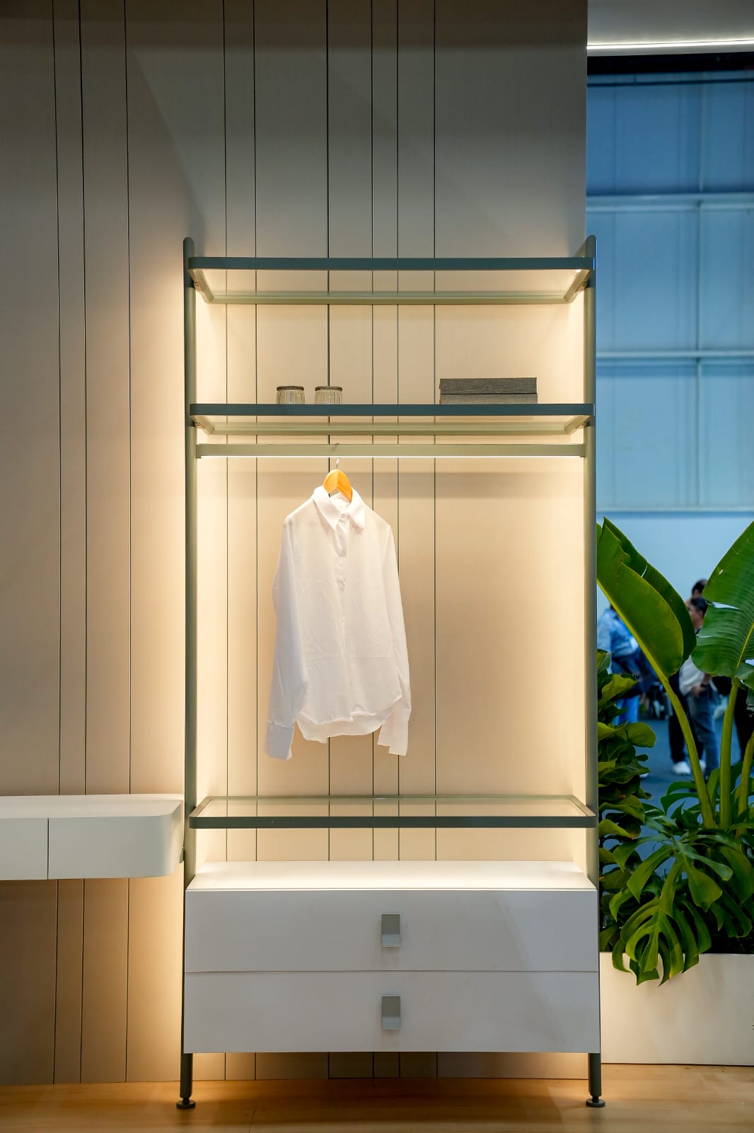 Lit modular wardrobe with aluminum framing and a hanging rail