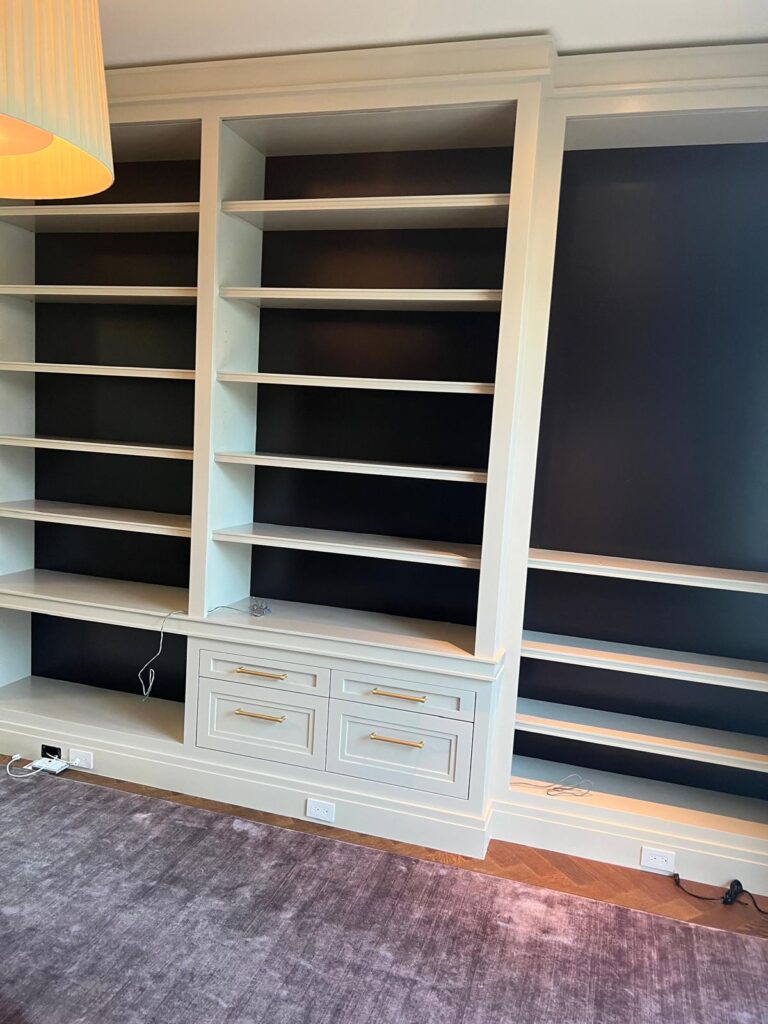 Built-in white bookshelves during installation