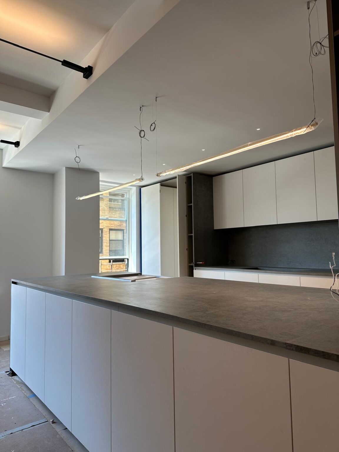 Kitchen with a long island and flat-panel cabinetry