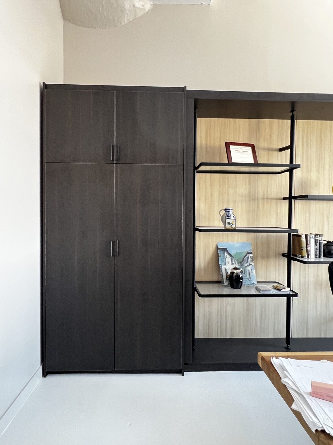 Dark wardrobe with open shelving alongside
